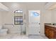 Bright bathroom with a walk-in glass door shower, toilet, and window at 13481 Pullman Dr, Spring Hill, FL 34609