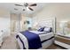 Comfortable bedroom featuring a ceiling fan, a large bed, and a view into the bathroom at 13481 Pullman Dr, Spring Hill, FL 34609