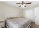 Bedroom with a ceiling fan, a patterned bed, and a bright window at 13481 Pullman Dr, Spring Hill, FL 34609