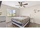 Bright bedroom with a ceiling fan, a wide window, and a nightstand at 13481 Pullman Dr, Spring Hill, FL 34609