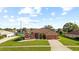 Inviting single-story home with a two-car garage, a screened entry, and a well-manicured front lawn at 13481 Pullman Dr, Spring Hill, FL 34609