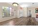 Bright and airy living room featuring wood flooring, large windows, and elegant light fixtures at 13481 Pullman Dr, Spring Hill, FL 34609