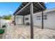 Backyard featuring a covered patio, grilling area, a well-maintained fence, and green shrubbery at 1404 Wood Ave, Clearwater, FL 33755