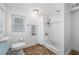 This bright bathroom has a new shower and a toilet at 1404 Wood Ave, Clearwater, FL 33755