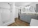 Updated bathroom showcasing a tiled shower and a double vanity sink at 1404 Wood Ave, Clearwater, FL 33755
