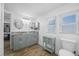 Bright bathroom with dual sinks, plenty of cabinet storage, and a separate toilet room at 1404 Wood Ave, Clearwater, FL 33755