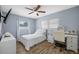 The stylish bedroom is decorated in a light blue color and has lots of natural light at 1404 Wood Ave, Clearwater, FL 33755
