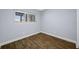 Bright bedroom featuring hardwood floors and a window with natural light at 1404 Wood Ave, Clearwater, FL 33755