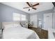 A bedroom featuring hardwood floors, a ceiling fan, and a vanity area at 1404 Wood Ave, Clearwater, FL 33755