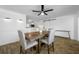 Inviting dining room with modern lighting, hardwood floors, and backyard access at 1404 Wood Ave, Clearwater, FL 33755