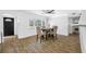 Bright dining room with a ceiling fan, hardwood floors, and backyard access at 1404 Wood Ave, Clearwater, FL 33755