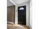 Welcoming entryway featuring a stylish black door with decorative glass and beautiful wood-look floors at 1404 Wood Ave, Clearwater, FL 33755