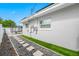 A beautifully landscaped exterior showing a well-maintained yard and stepping stones at 1404 Wood Ave, Clearwater, FL 33755