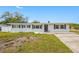 Charming single-story home features fresh paint, black shutters, and a well-maintained front yard at 1404 Wood Ave, Clearwater, FL 33755
