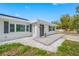 Inviting front exterior with stone walkway, tidy landscaping, and a charming entrance with dark shutters at 1404 Wood Ave, Clearwater, FL 33755
