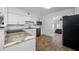 Modern kitchen with granite countertops, stainless steel appliances, and hardwood floors at 1404 Wood Ave, Clearwater, FL 33755