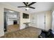 Bright living room showcasing open floor plan, ceiling fan, and a view of the kitchen at 1404 Wood Ave, Clearwater, FL 33755