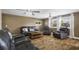 Comfortable living room features hardwood floors, bright windows, and modern ceiling fans at 1404 Wood Ave, Clearwater, FL 33755