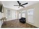Cozy living room featuring a ceiling fan, natural light from multiple windows, and wood-look floors at 1404 Wood Ave, Clearwater, FL 33755