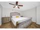 Cozy bedroom with a comfortable bed, wooden floors, and a ceiling fan at 1404 Wood Ave, Clearwater, FL 33755