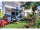 Cozy backyard with artificial turf, seating area, and lush landscaping at 1411 Water View W Dr, Largo, FL 33771
