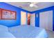 Cozy blue bedroom with ample closet space, providing a comfortable and organized living area at 1411 Water View W Dr, Largo, FL 33771