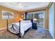 Bedroom with a view of the water; features neutral carpeting, sliding glass door to balcony and ceiling fan at 1411 Water View W Dr, Largo, FL 33771