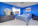 Bright blue bedroom with modern furniture, ample natural light, and a comfortable atmosphere at 1411 Water View W Dr, Largo, FL 33771