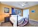 Bedroom with neutral carpet, ceiling fan, sliding glass door to balcony and ensuite bathroom at 1411 Water View W Dr, Largo, FL 33771