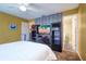Bedroom showing ensuite bathroom, ceiling fan and display cabinets at 1411 Water View W Dr, Largo, FL 33771