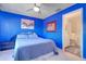 Well-lit blue bedroom with an en-suite bathroom, providing privacy and convenience at 1411 Water View W Dr, Largo, FL 33771