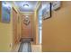 Well-lit foyer with warm yellow walls, wood flooring, and decorative accents at 1411 Water View W Dr, Largo, FL 33771