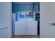 Laundry room with washer, dryer and overhead shelving at 1411 Water View W Dr, Largo, FL 33771