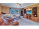 Cozy living room showcasing a large window, built-in shelving, and ample seating at 1411 Water View W Dr, Largo, FL 33771