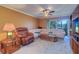 Comfortable living room featuring plush seating, a ceiling fan, and sliding glass doors at 1411 Water View W Dr, Largo, FL 33771