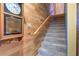 Carpeted staircase with wooden handrail, offering a warm and inviting transition between floors at 1411 Water View W Dr, Largo, FL 33771