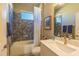 Bathroom featuring a shower/tub combo with mosaic tile surround and neutral vanity at 14466 Pioneer Ridge Dr, Hudson, FL 34667