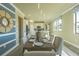 An airy dining room with large windows adjoins a spacious living room and kitchen at 14466 Pioneer Ridge Dr, Hudson, FL 34667