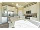 Bright kitchen with stainless steel appliances, white cabinets and an island with quartz countertops at 14466 Pioneer Ridge Dr, Hudson, FL 34667
