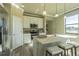 Modern kitchen featuring stainless appliances, bright cabinets, and eat in island with sink at 14466 Pioneer Ridge Dr, Hudson, FL 34667