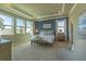 The main bedroom is bright and airy with large windows and an ensuite bathroom at 14466 Pioneer Ridge Dr, Hudson, FL 34667