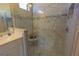 Close-up of a shower with a seat and marble surround in an elegant ensuite bathroom at 14466 Pioneer Ridge Dr, Hudson, FL 34667
