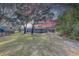 Large backyard with mature trees, partially fenced, and a gazebo near the pool at 1854 Wateroak W Dr, Clearwater, FL 33764