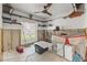Bedroom renovation with bare concrete walls, tile floor, large windows and a ceiling fan at 1859 Nevada Ne Ave, St Petersburg, FL 33703