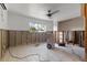 Bare room showing original concrete walls, tile floors and the opening to another room at 1859 Nevada Ne Ave, St Petersburg, FL 33703