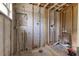 Partially renovated room featuring exposed framing, concrete walls with electrical work at 1859 Nevada Ne Ave, St Petersburg, FL 33703