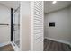 A modern bathroom features a glass shower with white marble tiles and a white, shuttered closet at 19029 Us Highway 19 N # 19C, Clearwater, FL 33764