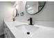 Bright bathroom with a double vanity, sleek black fixtures, and clean, minimalist design elements creating a modern space at 19029 Us Highway 19 N # 19C, Clearwater, FL 33764