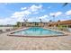 A large community pool with plenty of lounge chairs and a nearby view of the lake at 19029 Us Highway 19 N # 19C, Clearwater, FL 33764