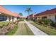 Attractive community featuring sidewalks, mature landscaping, and terra cotta roofs at 19029 Us Highway 19 N # 19C, Clearwater, FL 33764